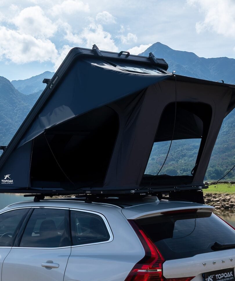 TOPOAK Galaxy Light hard shell rooftop tent open on an SUV by a mountain lake
