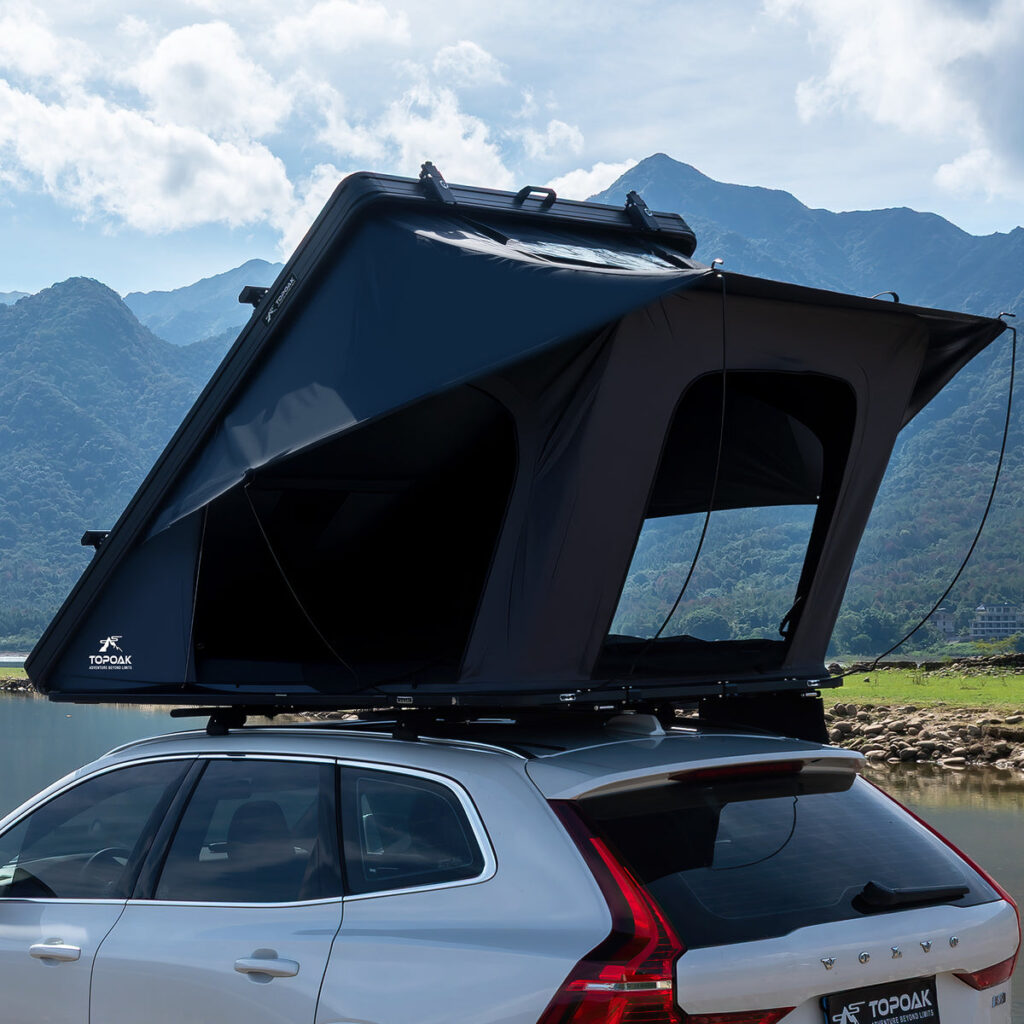 TOPOAK Galaxy Light hard shell rooftop tent open on an SUV by a mountain lake